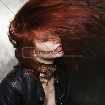 Woman with hair blowing.