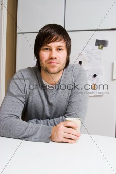 young man with cup of tea or coffee