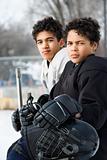 Boys in hockey uniforms.