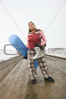 Woman holding snowboard.