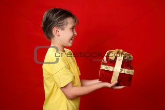 Smiling boy giving Christmas presents