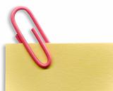 Pink paperclip on a yellow note with white background and shadow