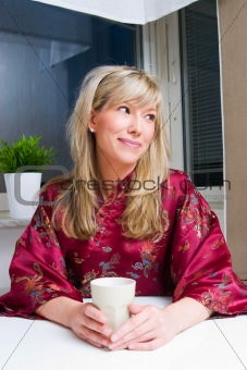 young woman with cup of tea or coffee