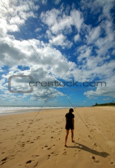 Lone woman walking at the beach