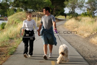 Couple walking their dog