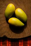 Three wooden mangoes.