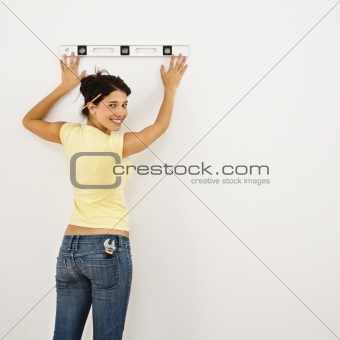 Woman leveling wall.