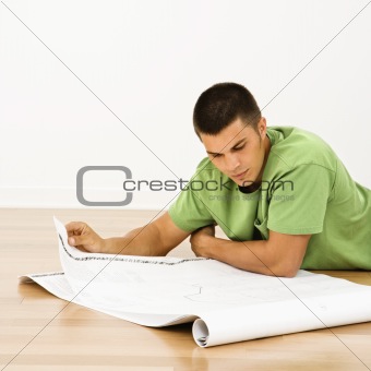 Man reading blueprints.