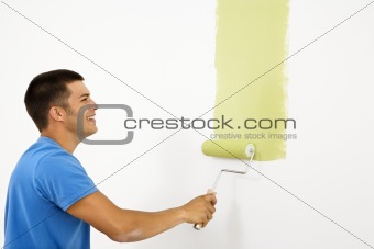 Smiling man painting.