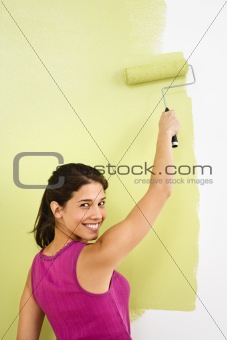 Smiling woman painting.