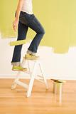 Female painter on ladder.