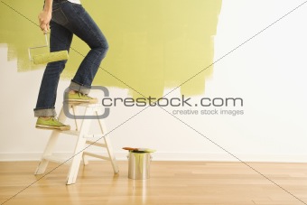 Woman painter on ladder.