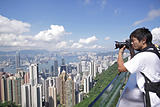 Tourist taking photo of Hong Kong skyline by his digital camera 