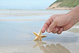 hand touching the starfish