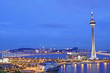 Urban landscape of Macau with famous traveling tower under sky near river in Macao, Asia.
