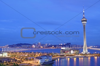 Urban landscape of Macau with famous traveling tower under sky near river in Macao, Asia.
