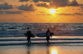 surfers at red sunset
