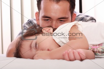 Father watch his beautiful baby while she sleeps