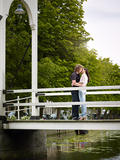 Boyfriend and girlfriend kissing on bridge