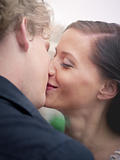 man and woman kissing and smiling