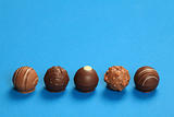 Five chocolate truffles in a row