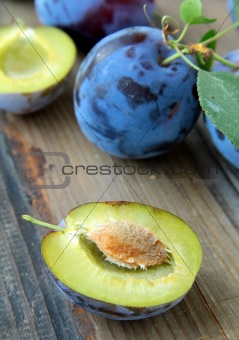 ripe juicy blue plum on a wooden table