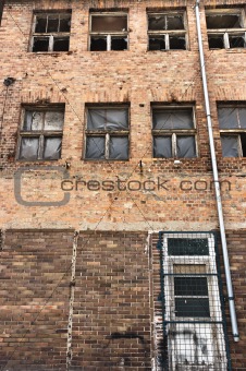 Angle shot of an abandoned industrial building with brick wall