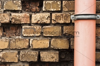 Drain pipe against brick wall