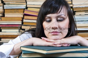 A beautiful young student girl with her books