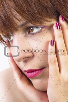 Young woman holding her face