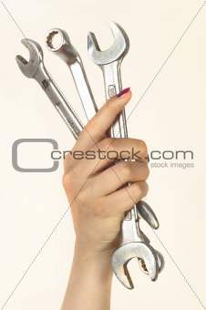 woman holding big chrome vanadium spanners in the hand