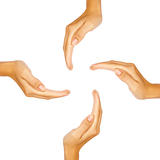 Four human hands forming a circle with copy-space in the middle