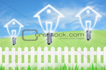 light bulb model of a house and white fence on sky