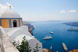 Old church dome and view of boats in Santorini