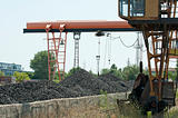 Crane and piles of coal