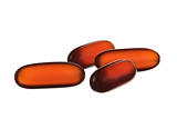 close up orange capsules isolated on white