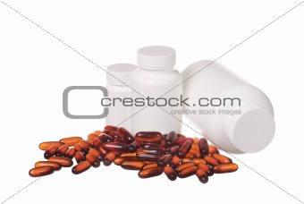 colorful pills and white containers isolated on white