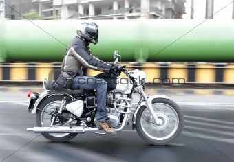 Motorcyclist riding through Industrial zone