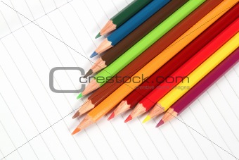Pencil crayons on white writing paper