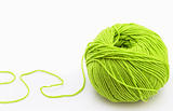 Threads for knitting on spokes of green  on white background