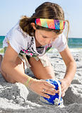 Child Building Sandcastle on a Beach