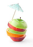 Layers of apples and oranges under umbrella