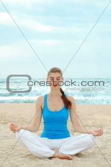 Beautiful woman practice yoga on the beach