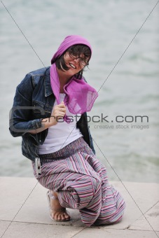 beautiful young woman on beach with scarf