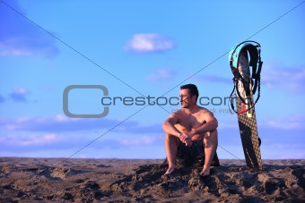 Portrait of a young  kitsurf  man at beach on sunset