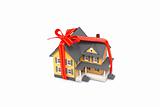 Gift miniature house with ed ribbon isolated on white background 