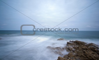 Long exposure photo of sea on rocks