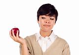 Pretty Hispanic Young Adult Female Looking at Apple in Hand Isolated on a White Background.