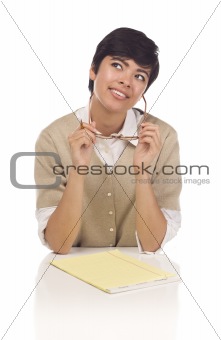 Daydreaming Hispanic Young Adult Female Student at Table with Pad of Paper, Pencil and Glasses Isolated on a White Background.