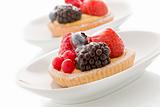 Pastry with berries on white background